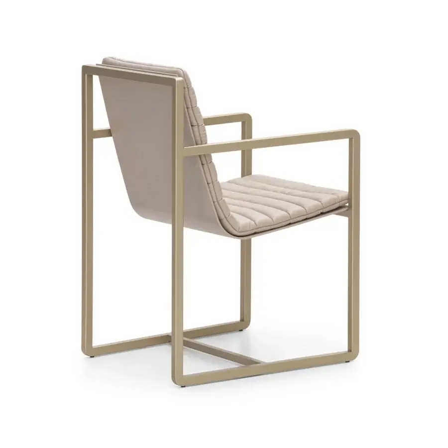 Exceptional Formitalia Kazimir armchair with smooth upholstery and muted golden metal framing