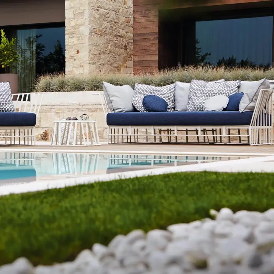 Distinguished Roberti Rattan Hamptons Graphics lounge chair with dark blue fabric cushions and white powder coated aluminum structure