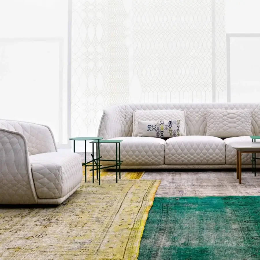 Exceptional Moroso Redondo lounge chair crafted in Italy with light cream quilted textile and black polypropylene feet