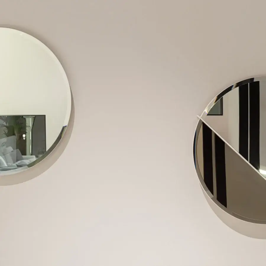 Distinguished Turri Zero mirror with a round glossy lacquered wood structure bisected by a metal line and bronzed clear glass panels