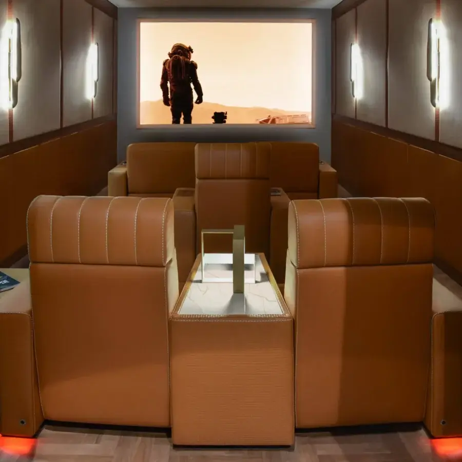 Exceptional Formitalia Dustin home cinema seating in warm brown leather-like material with white stitching and wood veneer accents
