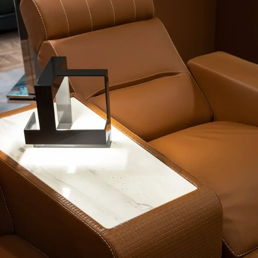 Lavish Formitalia Dustin home cinema seating in light brown leather-like material with white stitching and a lacquered base