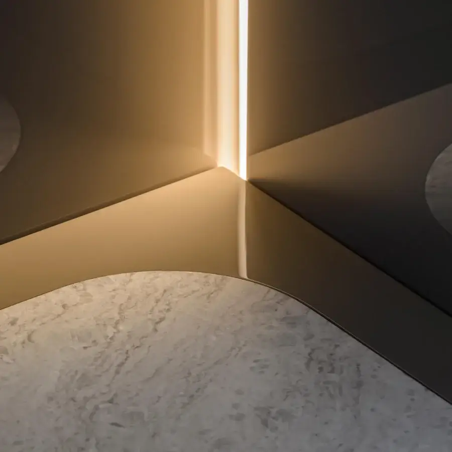 Exceptional Turri Zero cupboard with light tan wood, mottled stone surface and vertical LED light built in glass door