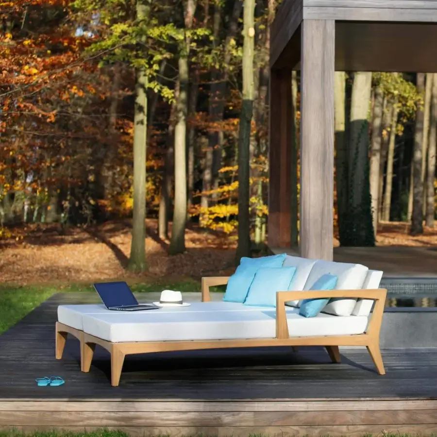 Sophisticated Royal Botania Zenhit lounger with teak wood structure and light beige fabrics displaying light blue accents