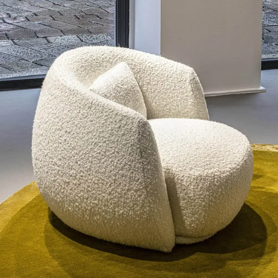 Superior Moroso Pacific lounge chair with rounded form upholstered in creamy textured fabric and internal steel frame