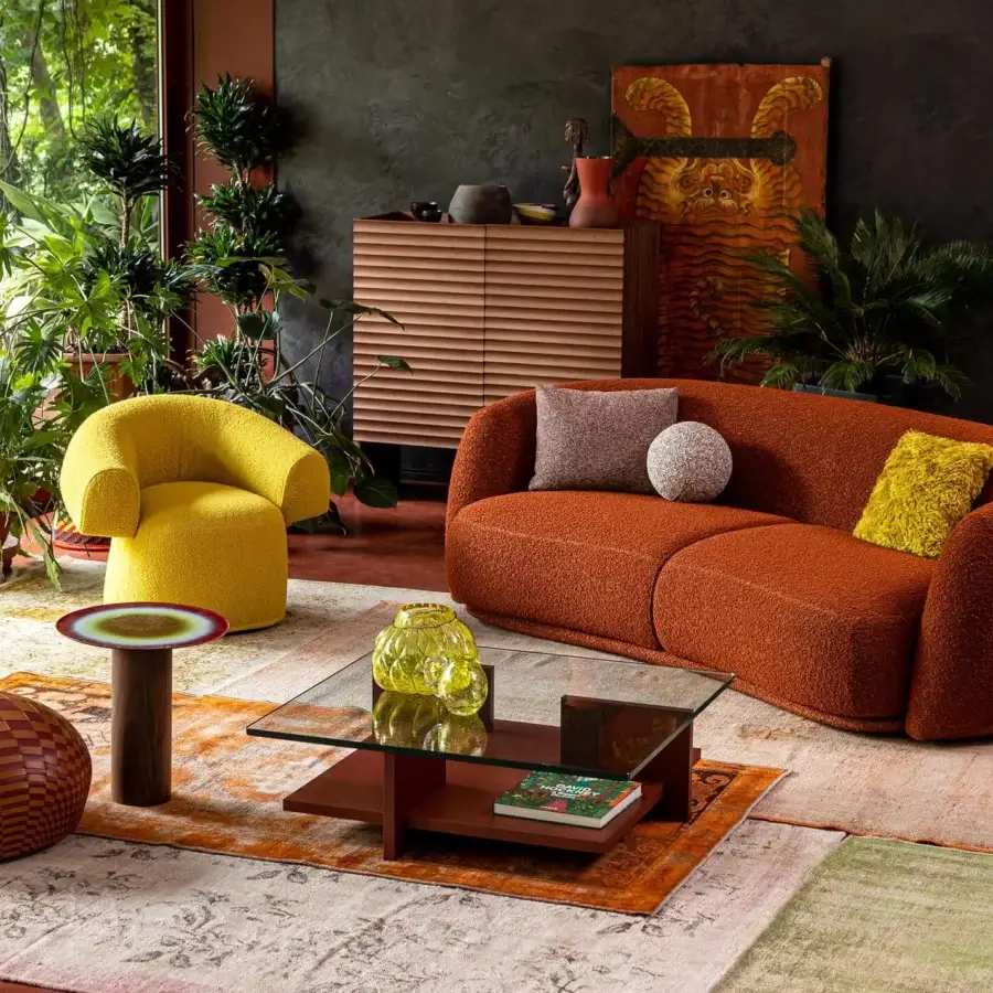 Lavish Moroso Pacific sofa with rounded silhouette upholstered in warm rusty orange textile and wooden steel structure