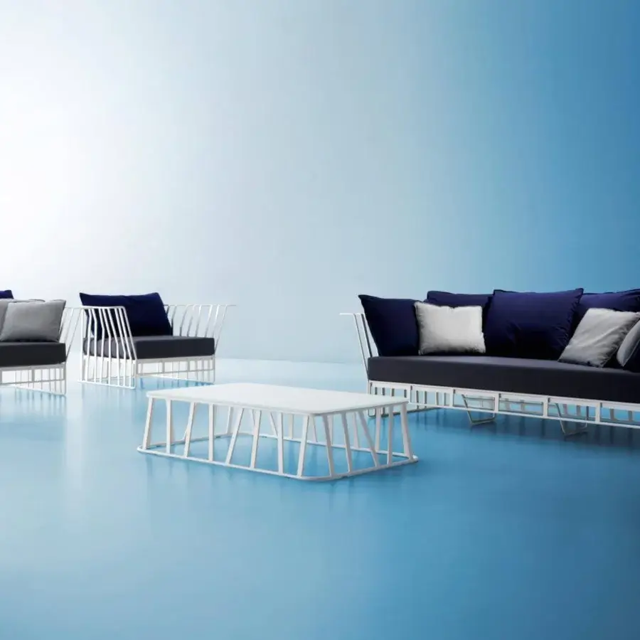 Distinguished Roberti Rattan Hamptons Graphics sofa with powder-coated aluminum and dark blue cushions complemented by grey and white pillows
