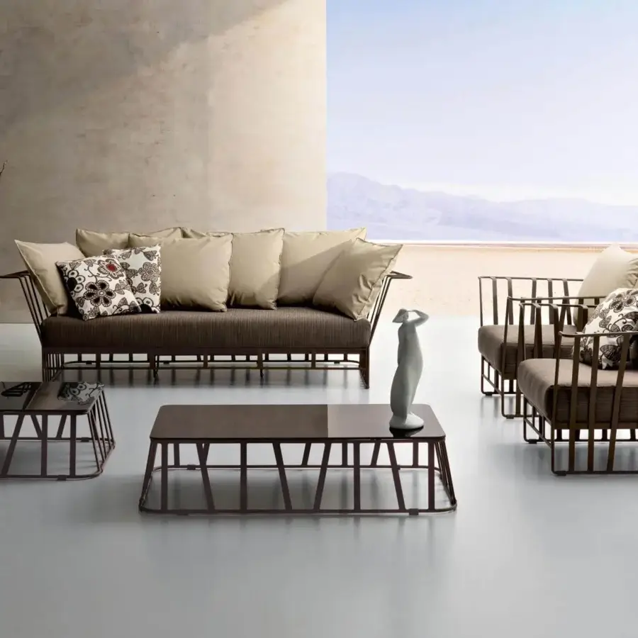 Elegant Roberti Rattan Hamptons Graphics sofa with powder-coated aluminum, light beige textile cushions and floral pillow
