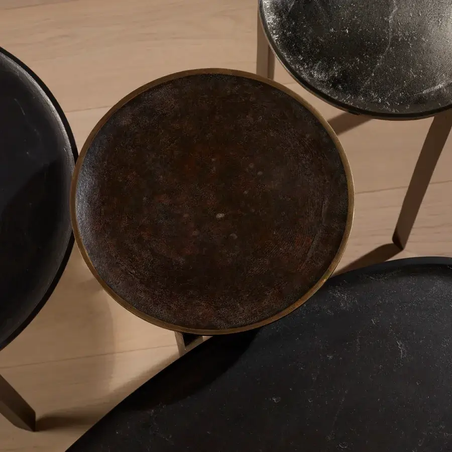 Distinguished Bellavista Batista table with cast aluminum structure and organically shaped top in a dark textured finish with metallic rim