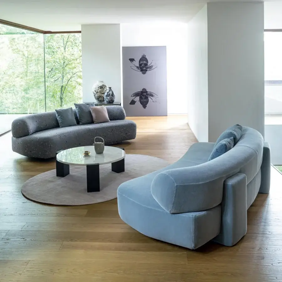 Elegant Moroso Gogan sofa sculpted like a river stone with light blue removable fabric and a wooden structure