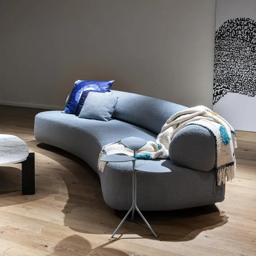 Superior Moroso Gogan sofa presenting a soft, irregular seat upholstered in light blue-gray fabric with a wooden structure finish