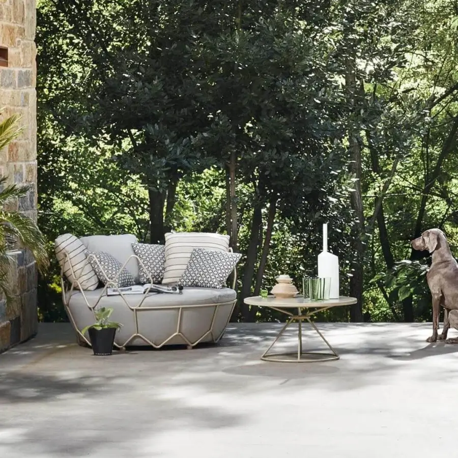 Distinguished Roberti rattan coffee table with a light powder-coated aluminum top and geometric stainless steel base in a light gold tone finish