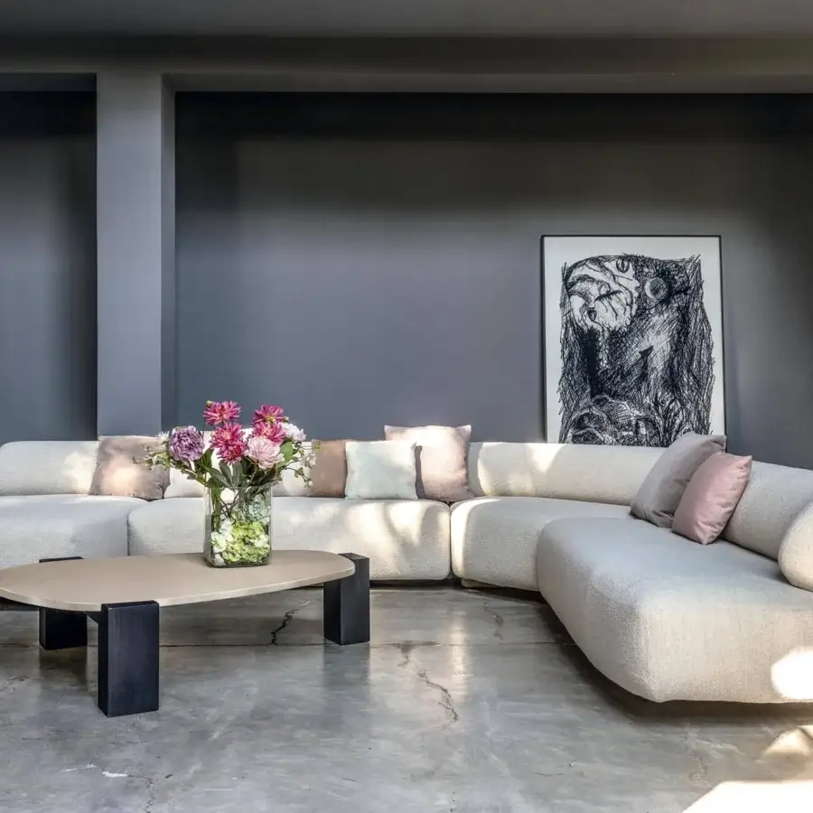 Superior Moroso Gogan sectional with a low profile and plush cushions upholstered in textured off-white fabric with a wooden structure