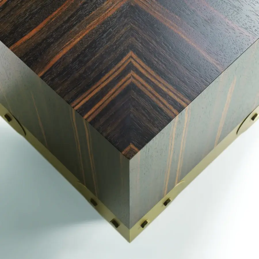 Distinguished Bellavista Strapp coffee table with dark-stained chevron European wood and brass cladding exhibiting a cubic form