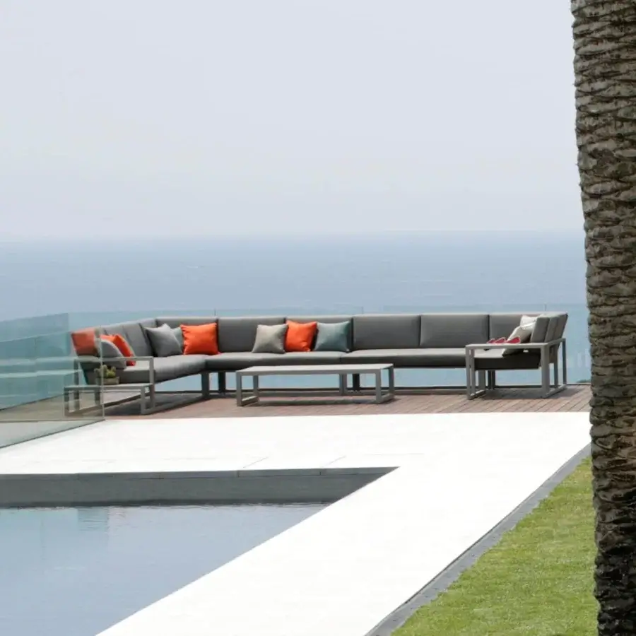 Sophisticated Royal Botania Ninix lounge sectional with stainless steel frame and Batyline seat in gray, complemented by accent pillows