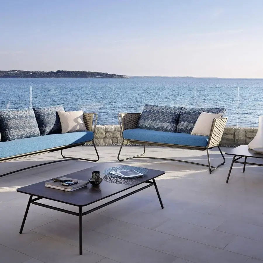 Elegant Roberti Rattan Portofino sofa with blue textile cushions and woven sides crafted in powder-coated aluminum with Nautic Rope