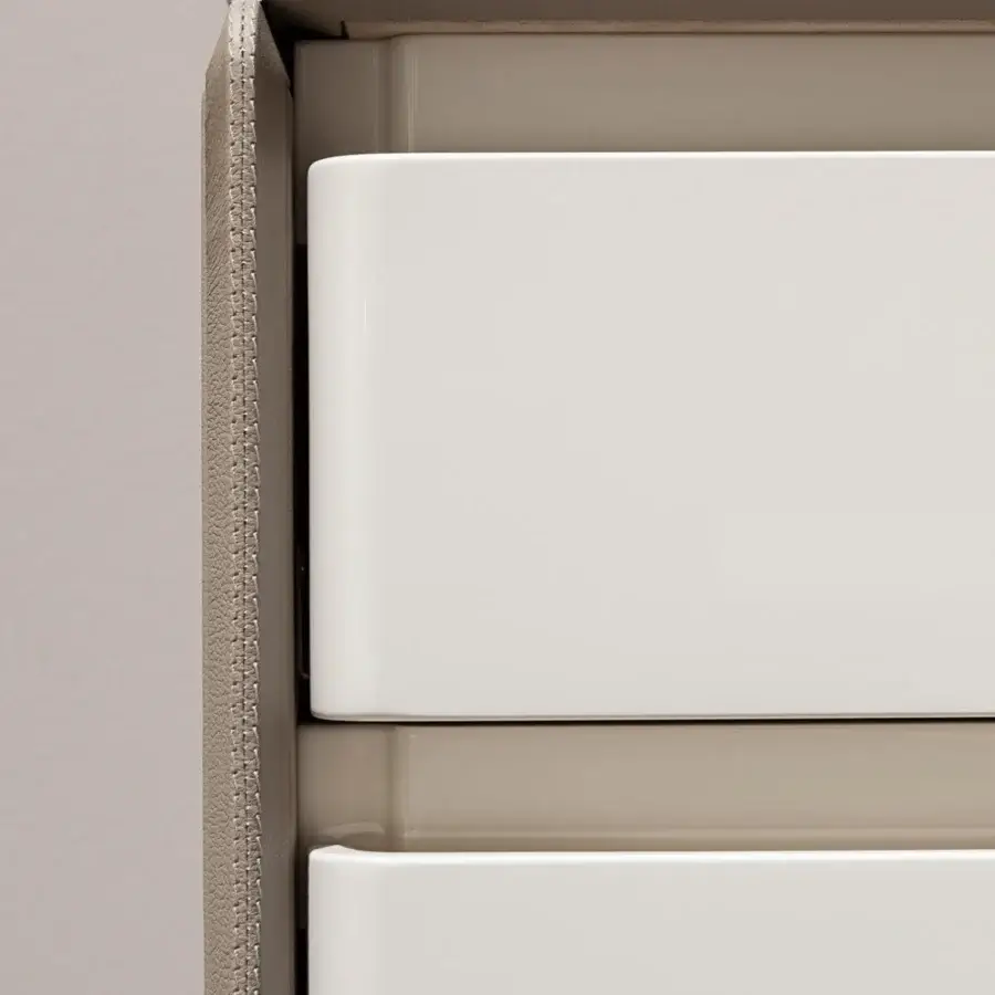 Distinguished Turri Zero dresser with rounded glossy white lacquered drawers and textured synthetic leather panels with platinum detailing
