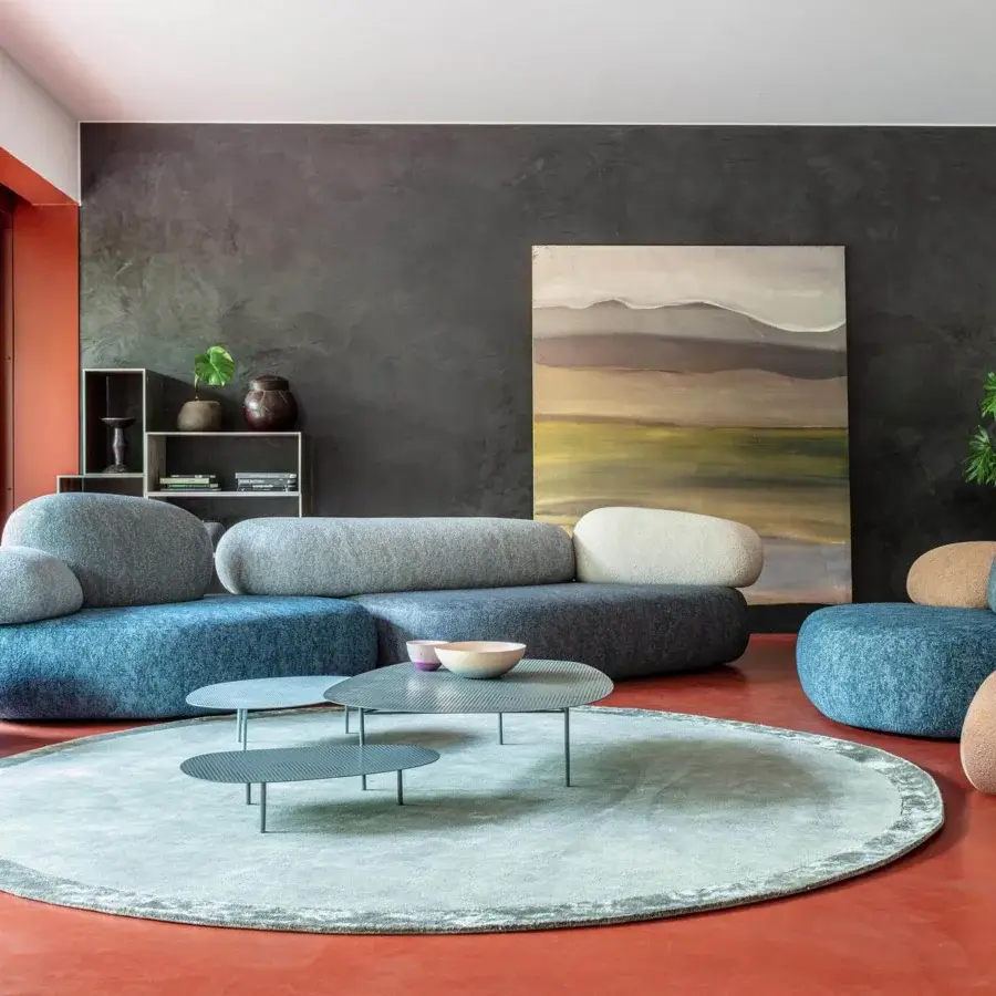 Innovative Moroso Pebble Rubble lounge chair upholstered in medium blue fabric resembling smooth stones with organic form
