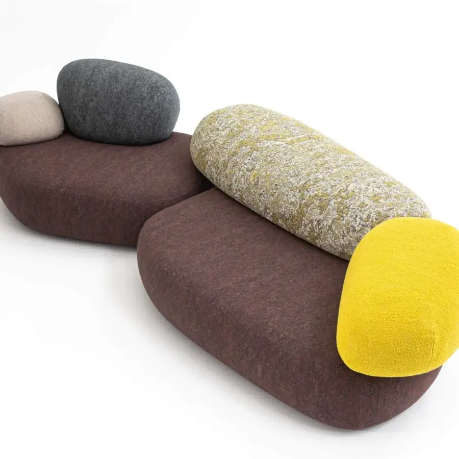 Lavish Moroso Pebble Rubble lounge chair with organic forms upholstered in matte fabric and patterned pillows