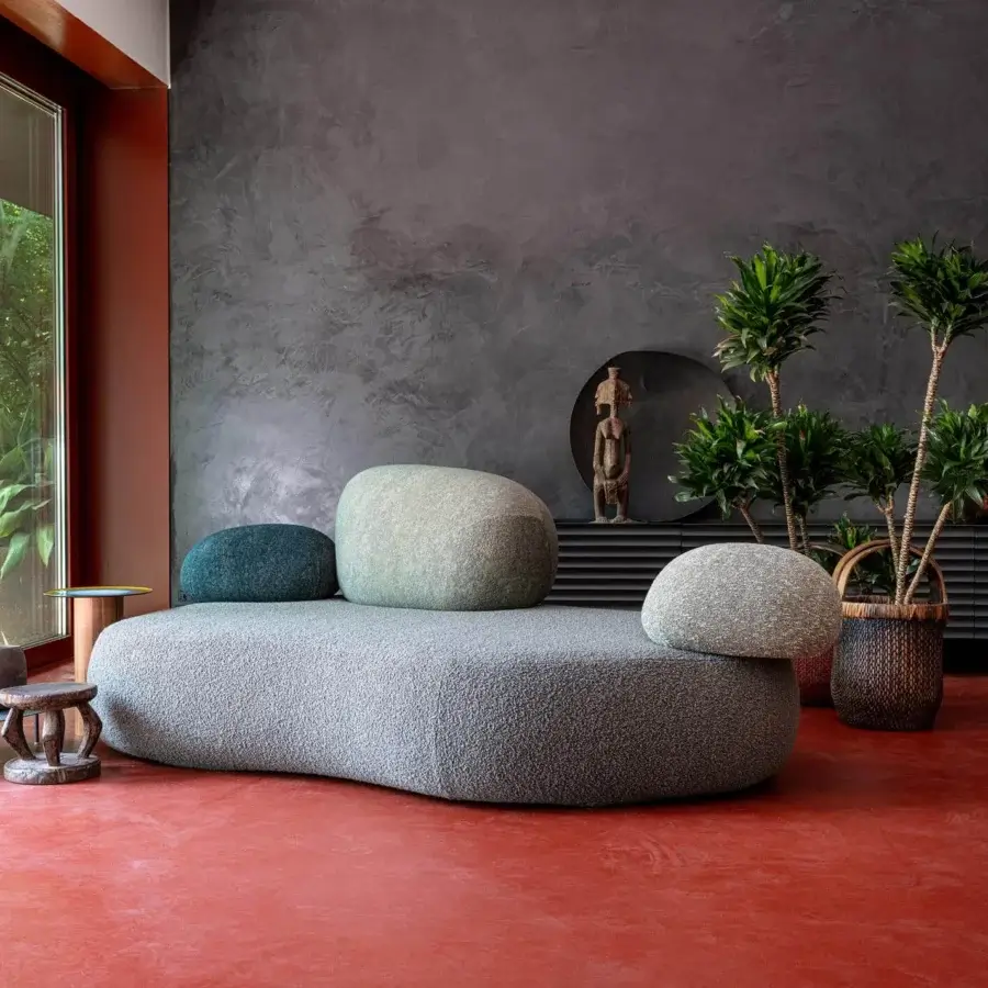 Innovative Moroso Pebble Rubble sofa with polyurethane foam volumes upholstered in textured grayish-blue fabric and rounded teal cushions