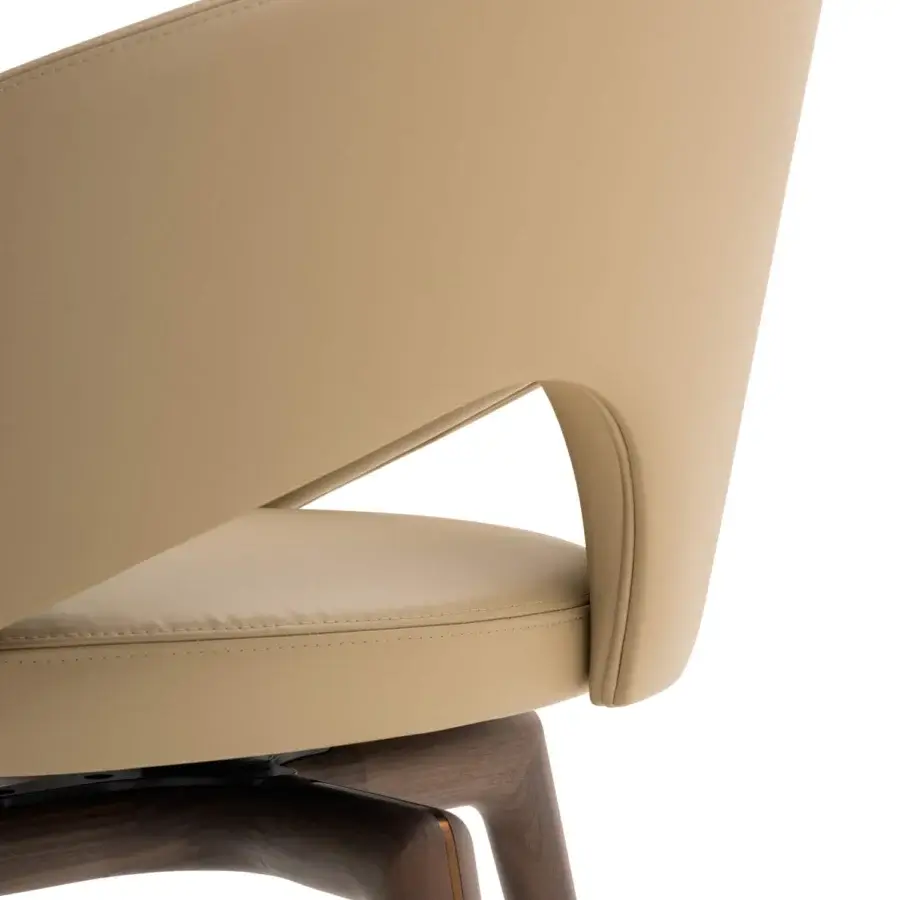 Exceptional Turri Blues armchair displays a continuous curved silhouette upholstered in tan leather with a dark wood base and metal accents