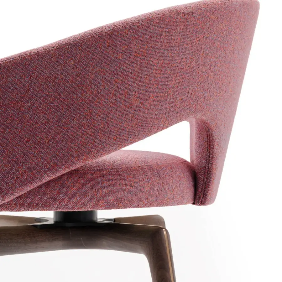 Exceptional Turri Blues armchair presents a sculptural form upholstered in reddish-purple textile with a dark wood base
