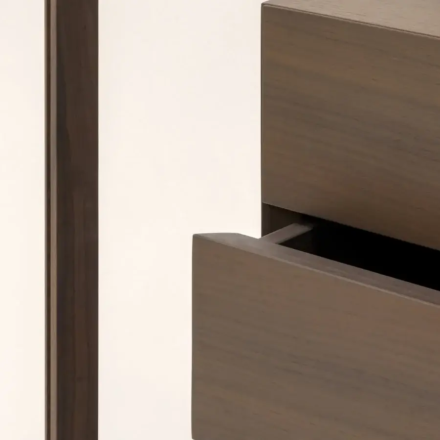 Elegant Turri Blues cupboard with glass sides meeting drawers finished with sleek metal edges in dark brown stain