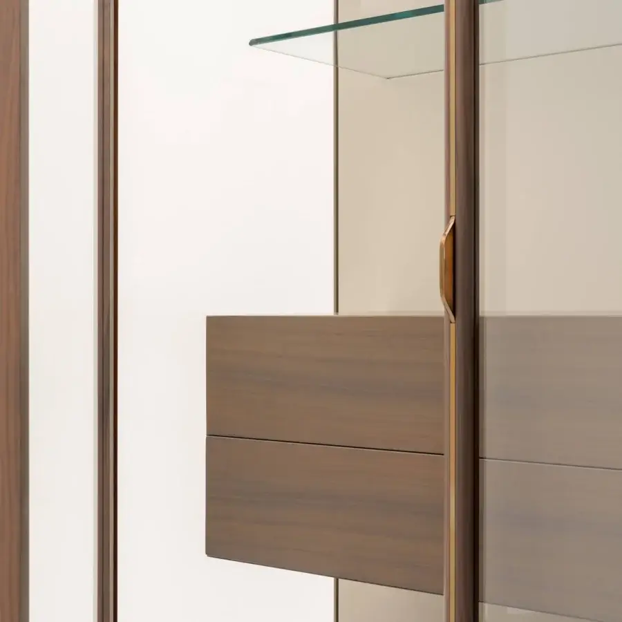 Distinguished Turri Blues cupboard with glass sides meeting solid drawers in medium brown wood and golden metal accents