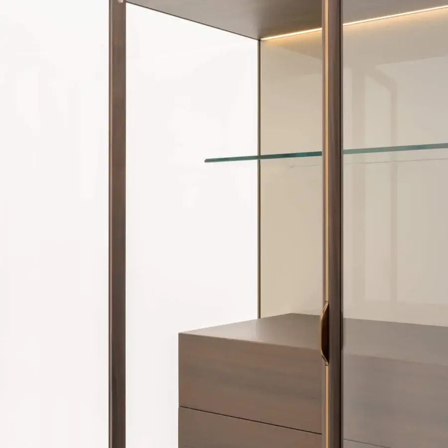 Elegant Turri Blues cupboard with glass sides meeting solid drawers in smooth matte medium brown wood