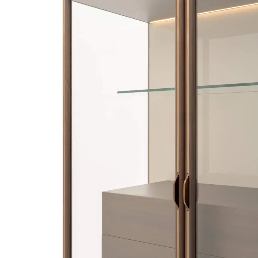 Superior Turri Blues cupboard with glass sides meeting wood drawers detailed with metal edges in matte medium-toned brown and gold trim