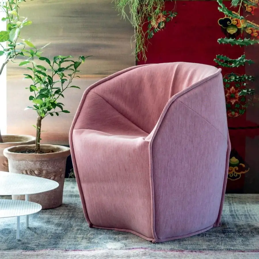 Elegant Moroso M.a.s.s.a.s lounge chair upholstered in light pink textile with textured matte finish crafted in Italy