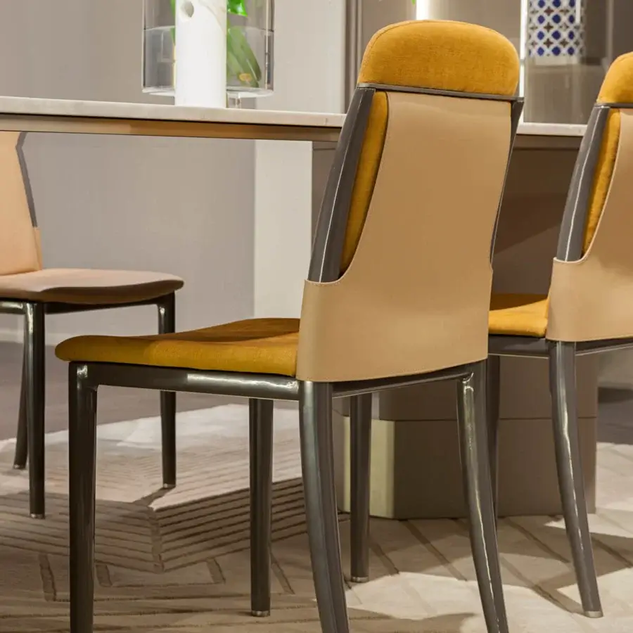 Distinguished Turri Zero chair with tan leather, golden-yellow fabric, lacquered wood legs and dark gray metal accents