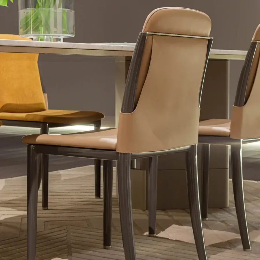 Sophisticated Turri Zero chair with light tan leather upholstery, dark gray metal frame and lacquered wooden legs
