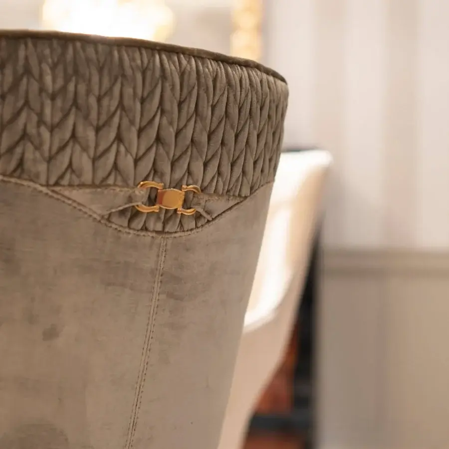 Elegant Formitalia Dome armchair in grey textile with seam detailing and gold-colored clasp, built with lacquered legs and metal feet
