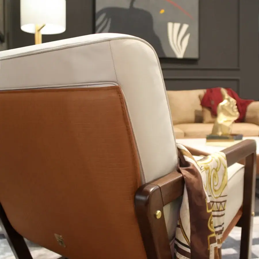 Sophisticated Formitalia Enya lounge chair upholstered in light material and textured brown leather with a dark stained wood frame