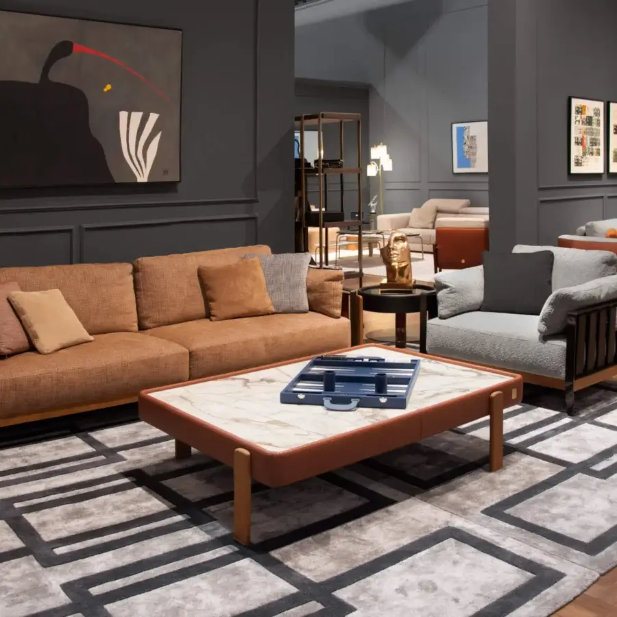 Superior Formitalia Daniela sofa with light brown textile upholstery, sleek leather straps and a sturdy wood base with a matte finish