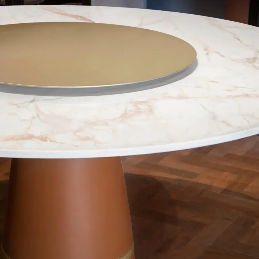 Distinguished Formitalia Iside table with beige marbled top and brown leather covering complemented by gold metal accents