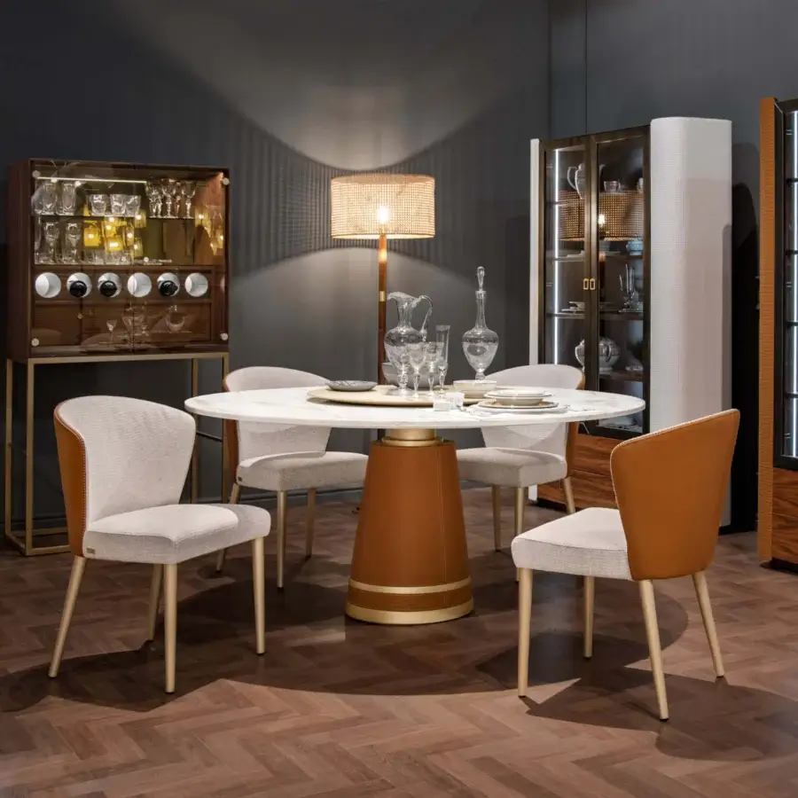 Distinguished Formitalia Iside chair built with light beige fabric and tan exterior, supported by metallic-lacquered legs