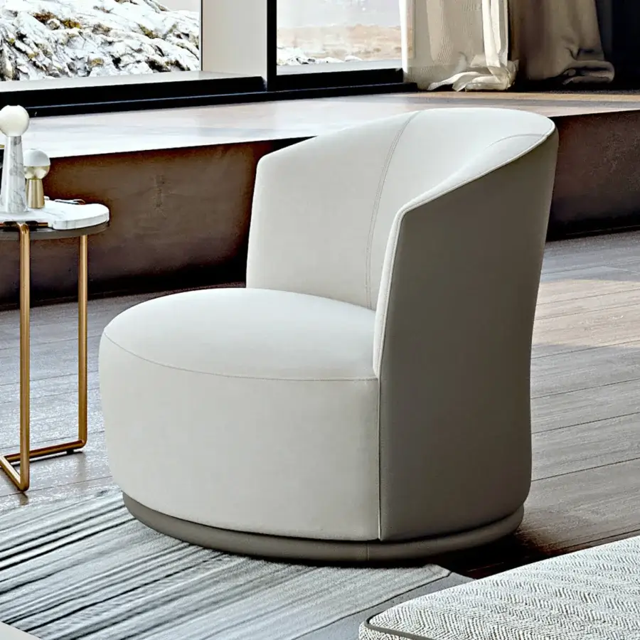 Elegant Turri Blues lounge chair with two-tone upholstery in off-white textile and darker gray leather, exhibiting a smooth matte finish