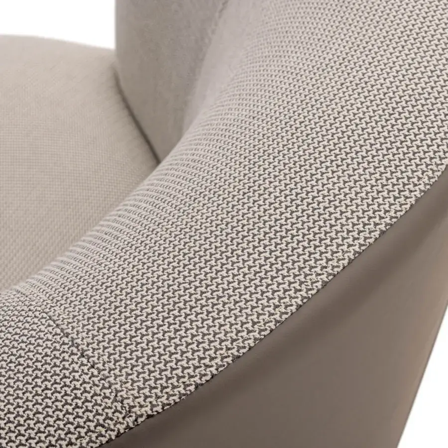 Superior Turri Blues lounge chair upholstered in textured neutral beige textile with smooth dark brown leather trim
