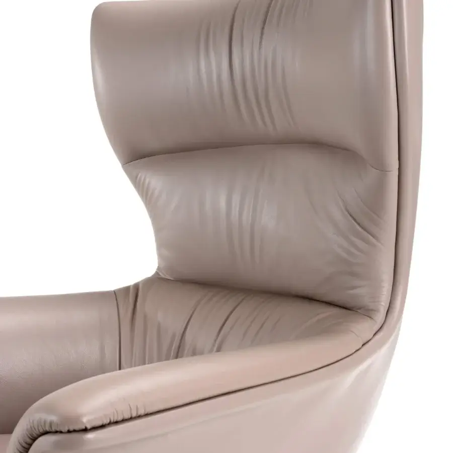 Distinguished Turri Blues armchair with ergonomic seat upholstered in light taupe Italian leather or fabric, showcasing a curved sculpted backrest