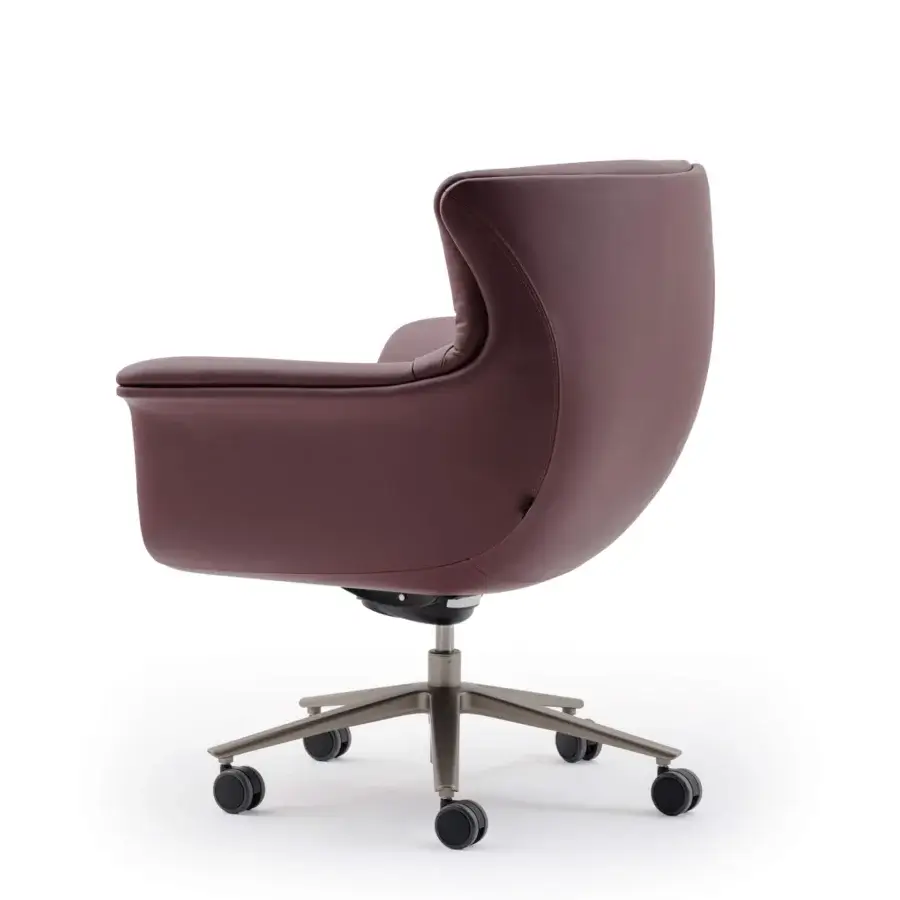 Sophisticated Turri Blues armchair with ergonomic seat upholstered in smooth reddish-brown Italian leather and matte metal base