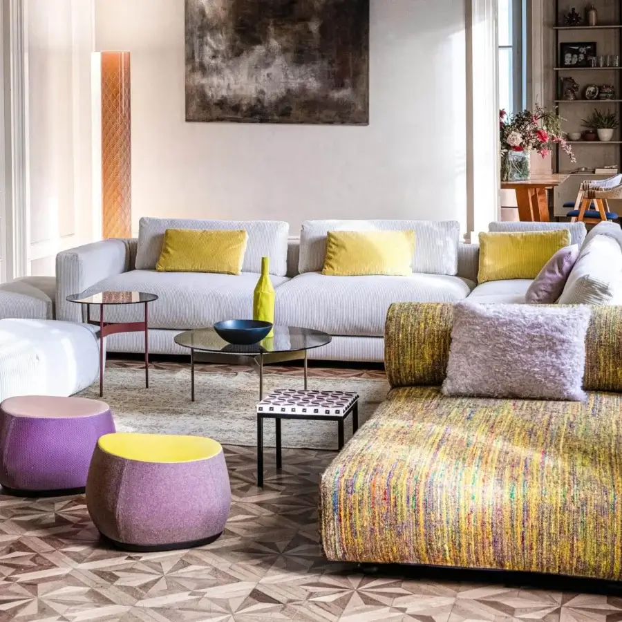 Superior Moroso Salon Nanà sectional with light textile upholstery, yellow pillows and striped chaise, built with dark stained beech feet