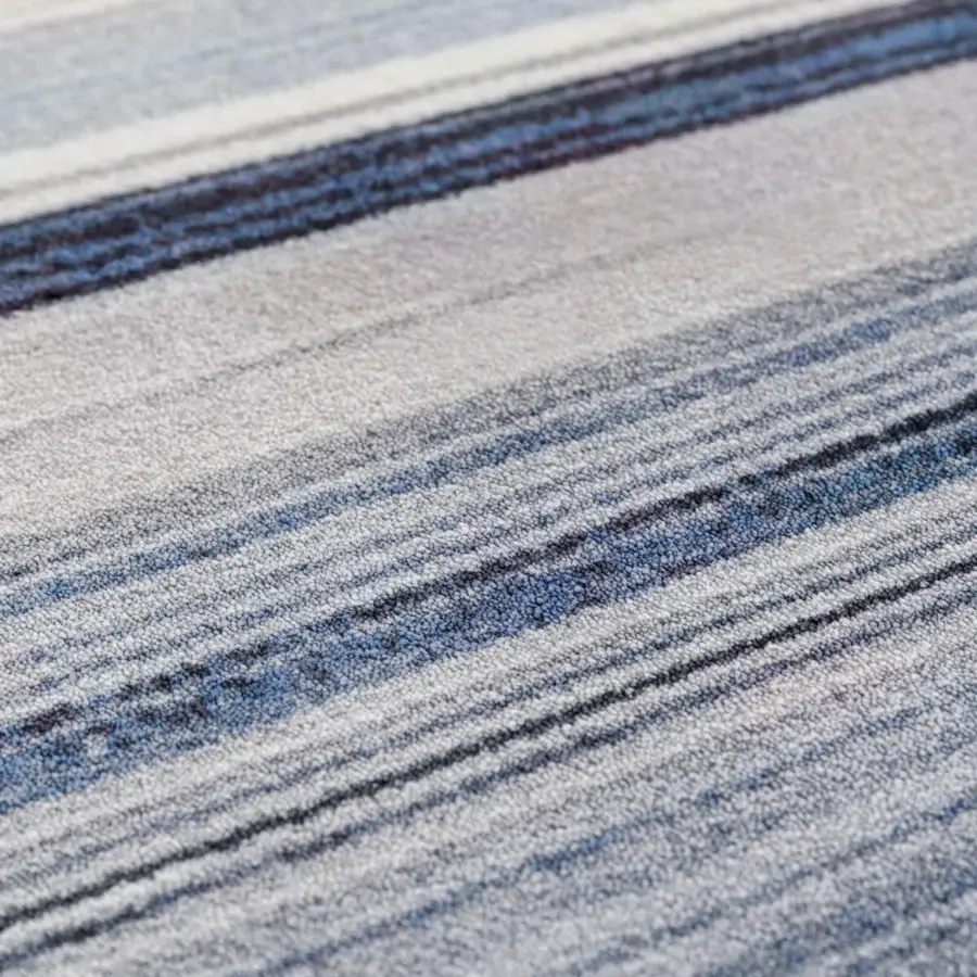 Exceptional Turri Blues rug displaying contemporary stripes in shades of gray and blue with a glossy tufted polyamide base