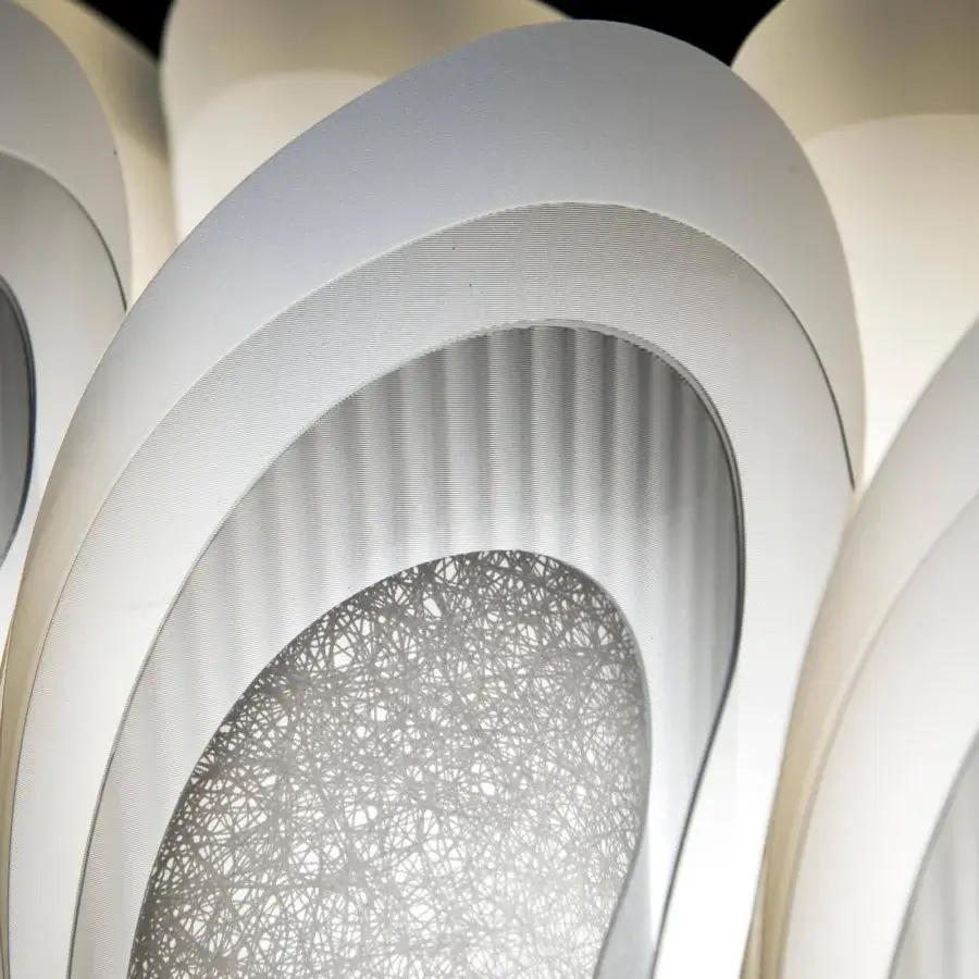 Elegant Slamp Fiordlys linear suspension lamp crafted from matte Opalflex with overlapping petal-like segments and brighter gradients