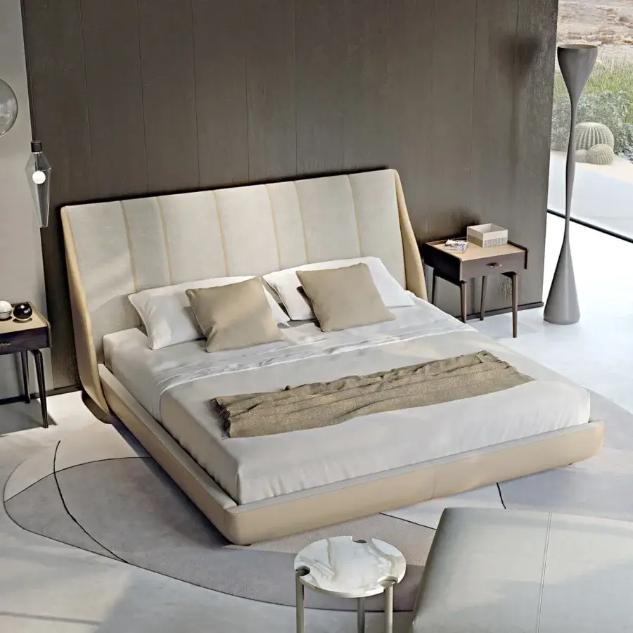 Distinctive Turri Blues bed presents a fully padded form upholstered in light beige textile with curved lighter beige detailing
