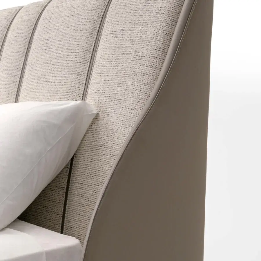 Lavish Turri Blues bed exhibits vertical padded sections in neutral textile with curved light brown leather detailing crafted in Italy