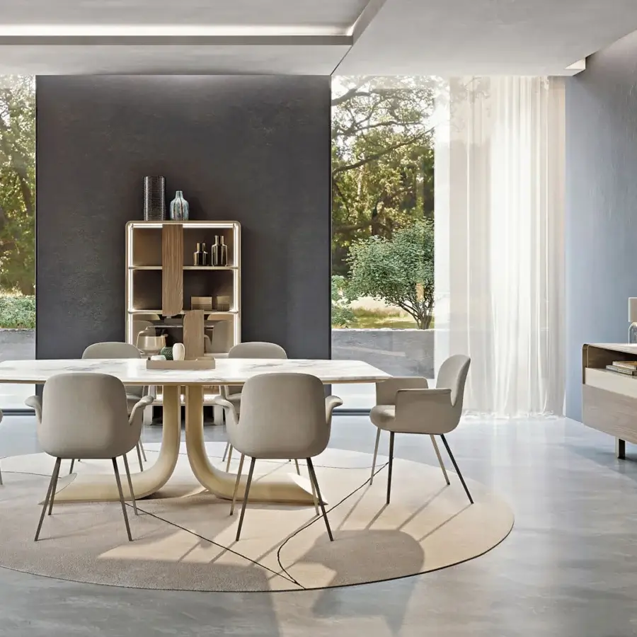 Distinguished Turri Soul table showcases a serpentine central leg with a dynamic oblique cut in light-toned stone and synthetic material
