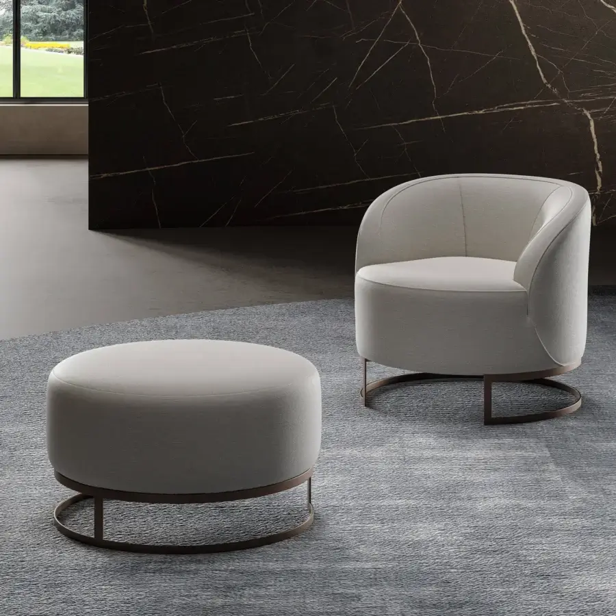 Distinguished Swan Italia Venus ottoman upholstered in subtly textured light gray fabric with a dark metal base and piping detail