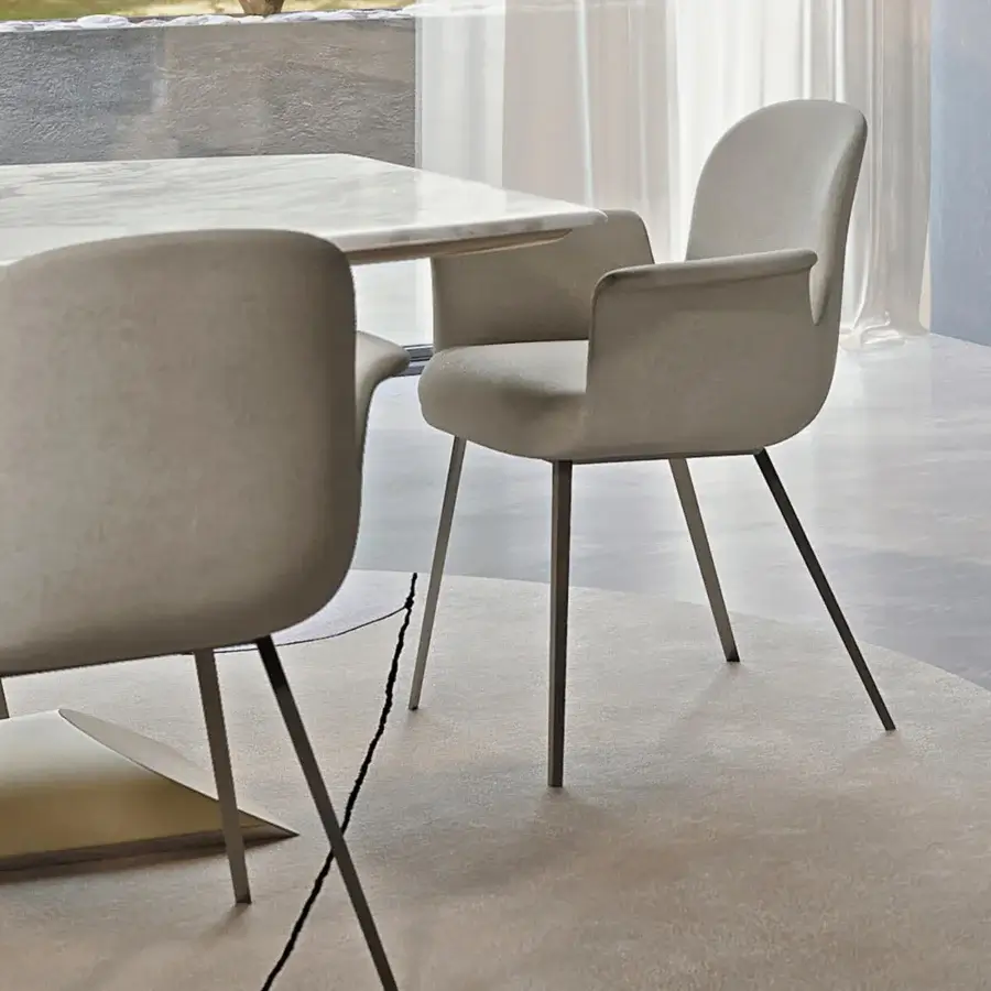 Superior Turri Soul armchair with light beige textile upholstery and matte metal legs exhibiting sleek curved lines